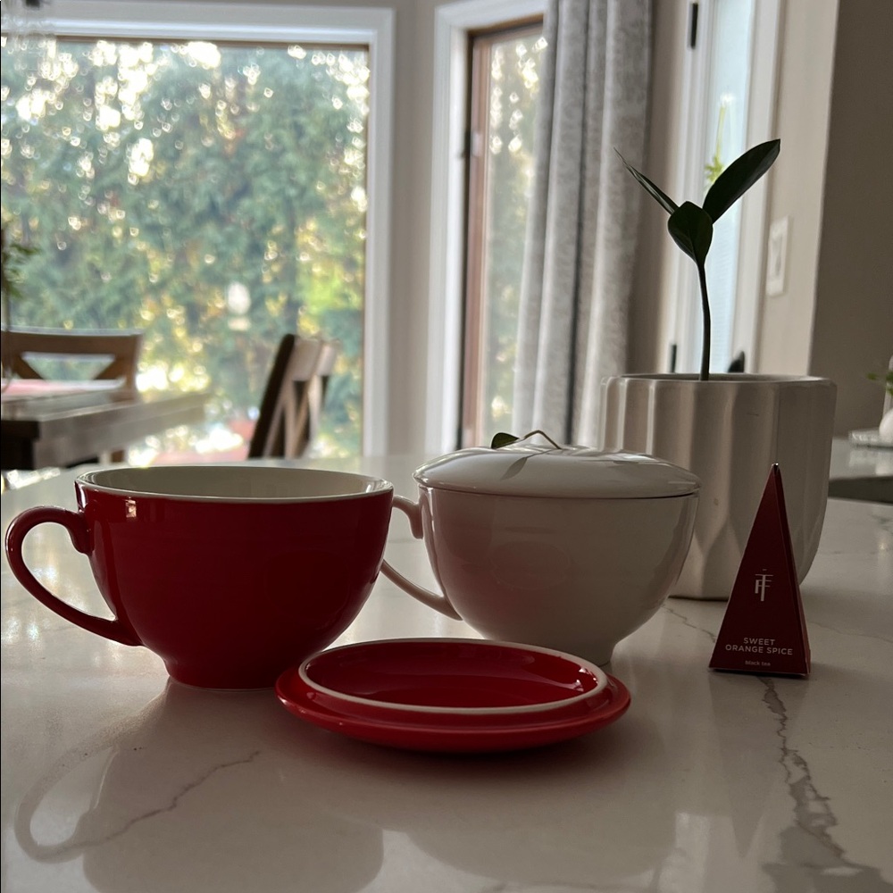 Two Tea Forte tea cups with lids.